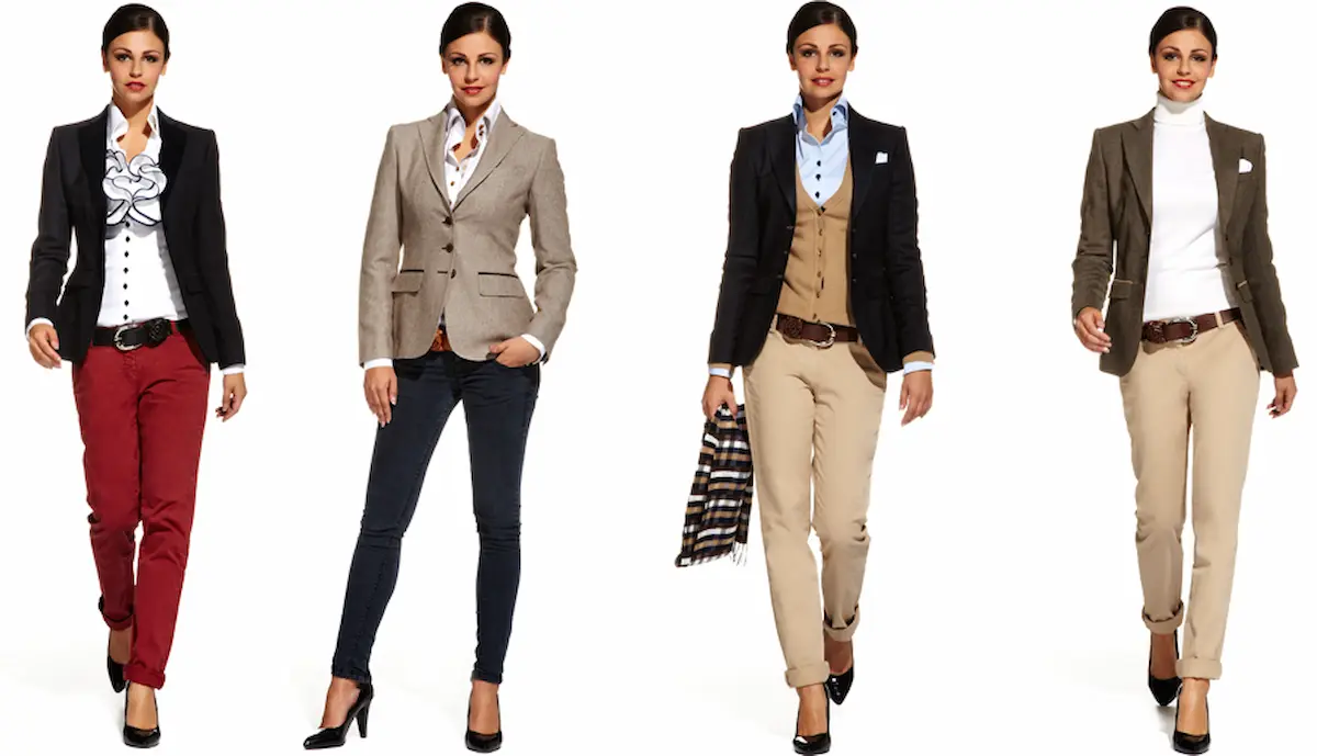 Four women stand confidently, each wearing a different stylish and professional outfit. Outfits include blazers, blouses, trousers, and heels in a range of colors such as black, beige, and maroon. Each woman showcases a unique, polished look. Smart Casual Attire for Ladies  