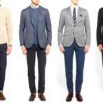 Four male mannequins showcase different smart casual outfits. From left to right: (1) Cream sweater with navy pants and brown tote bag, (2) Blue checkered blazer over blue sweater with navy pants, (3) Grey blazer with navy tie and pants, (4) Black blazer over blue sweater with black pants. Smart Casual